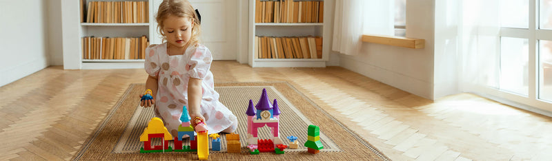 Young child playing with toys on the floor