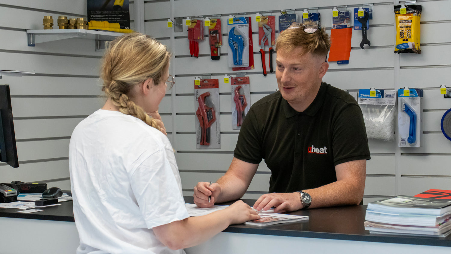 Staff talking to a customer about underfloor heating solutions